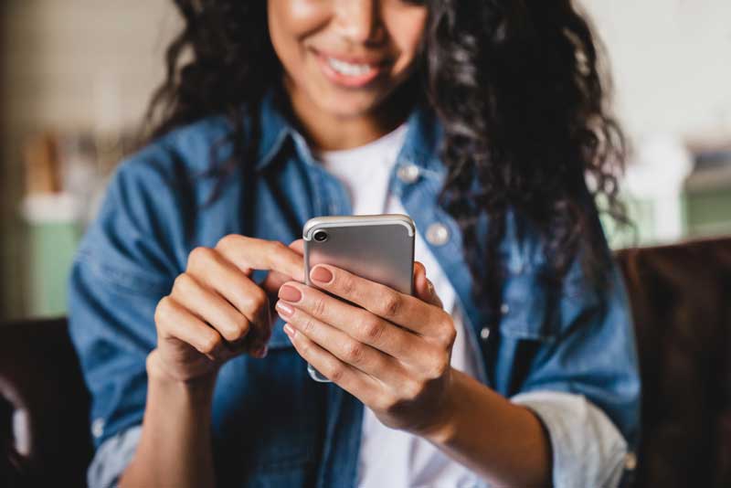 Post a gig with YesGig, young woman on a smartphone posting a job
